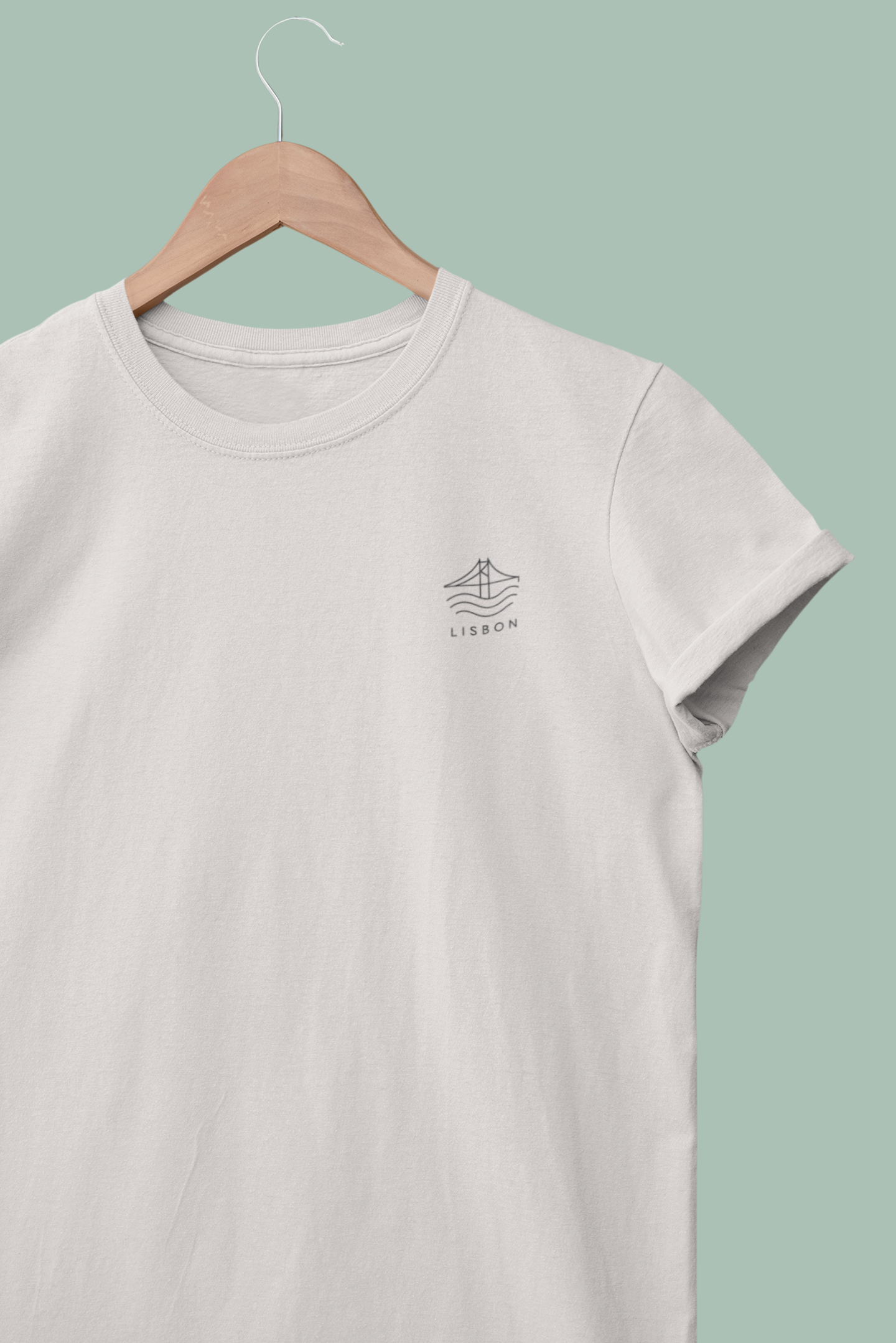 White t-shirt with a logo on a hanger against a light green background