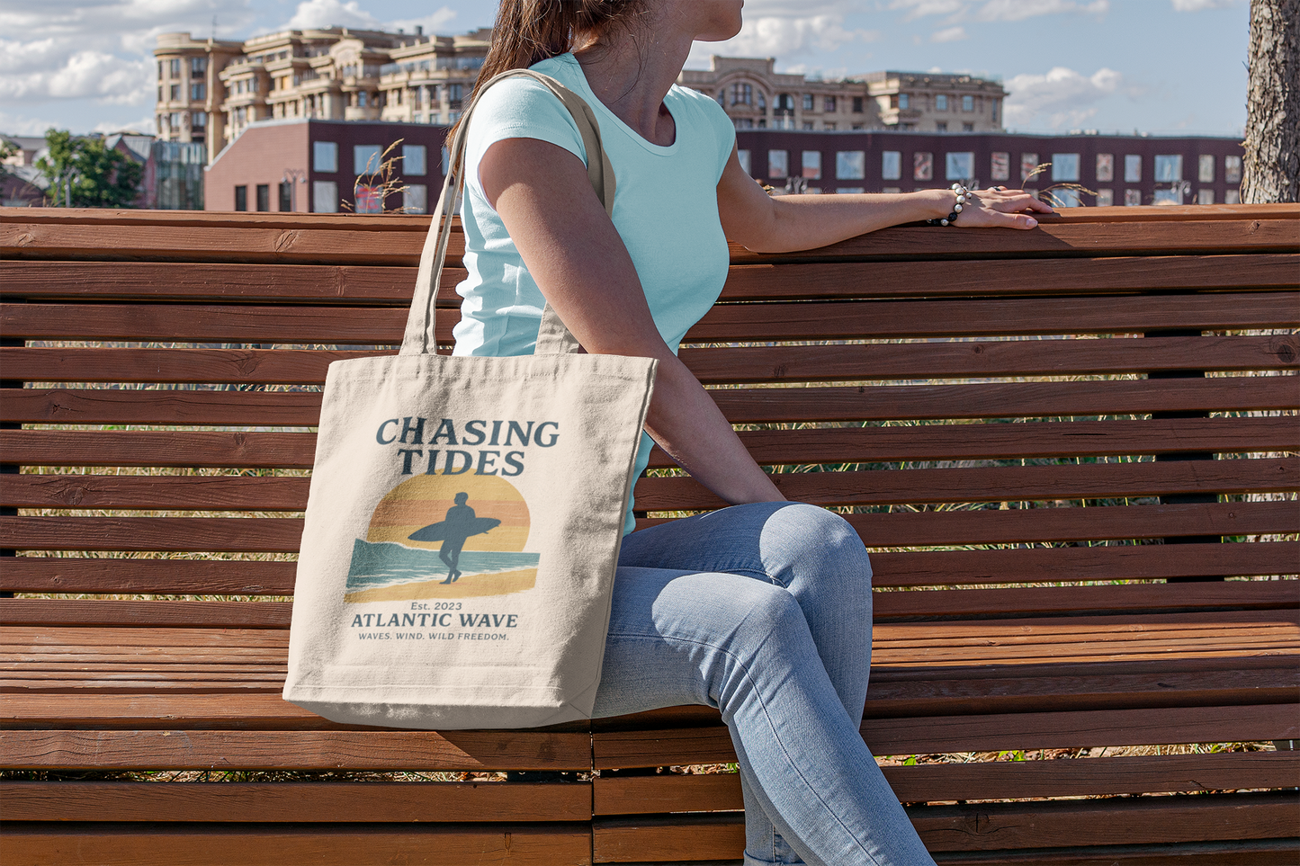 Side view of surf-style cotton tote with wave-themed typography.
