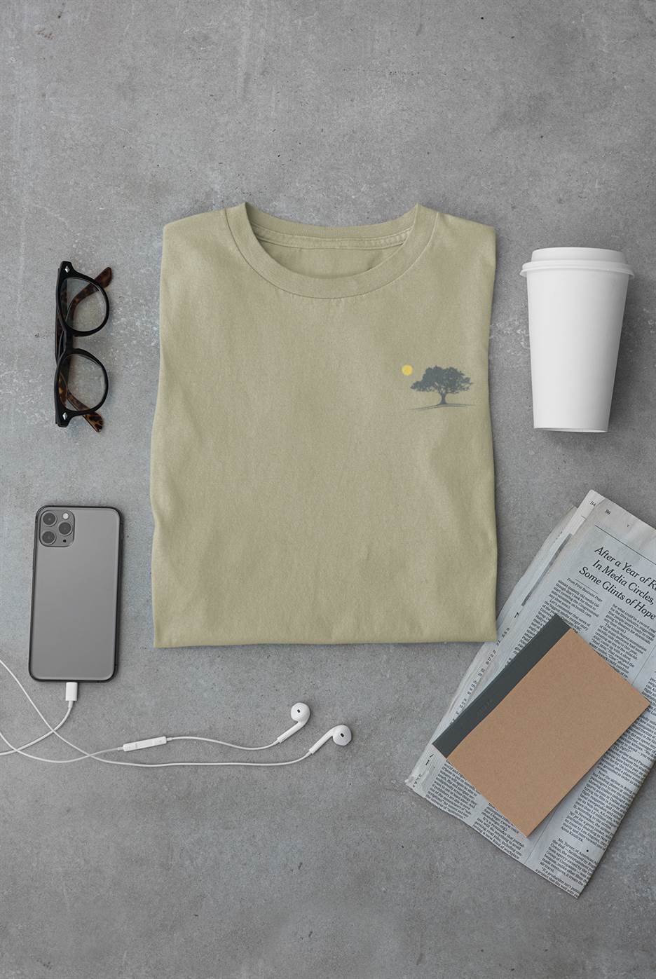 Minimalist unisex organic T-shirt in sage green featuring an oak tree and sunset design, inspired by Evora. Soft, sustainable cotton for everyday wear.