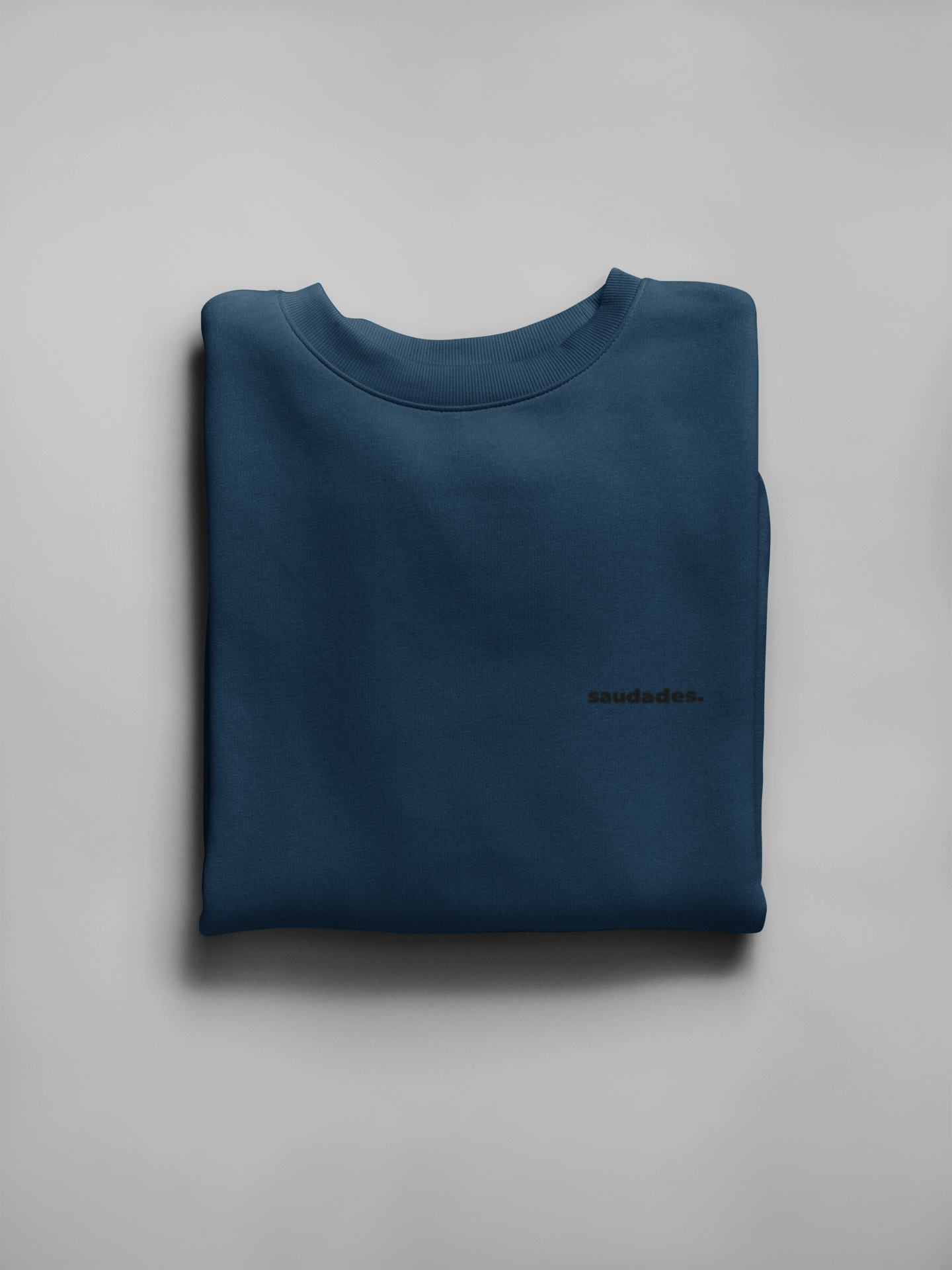 Saudade sweatshirt folded with logo tag and ready for packaging