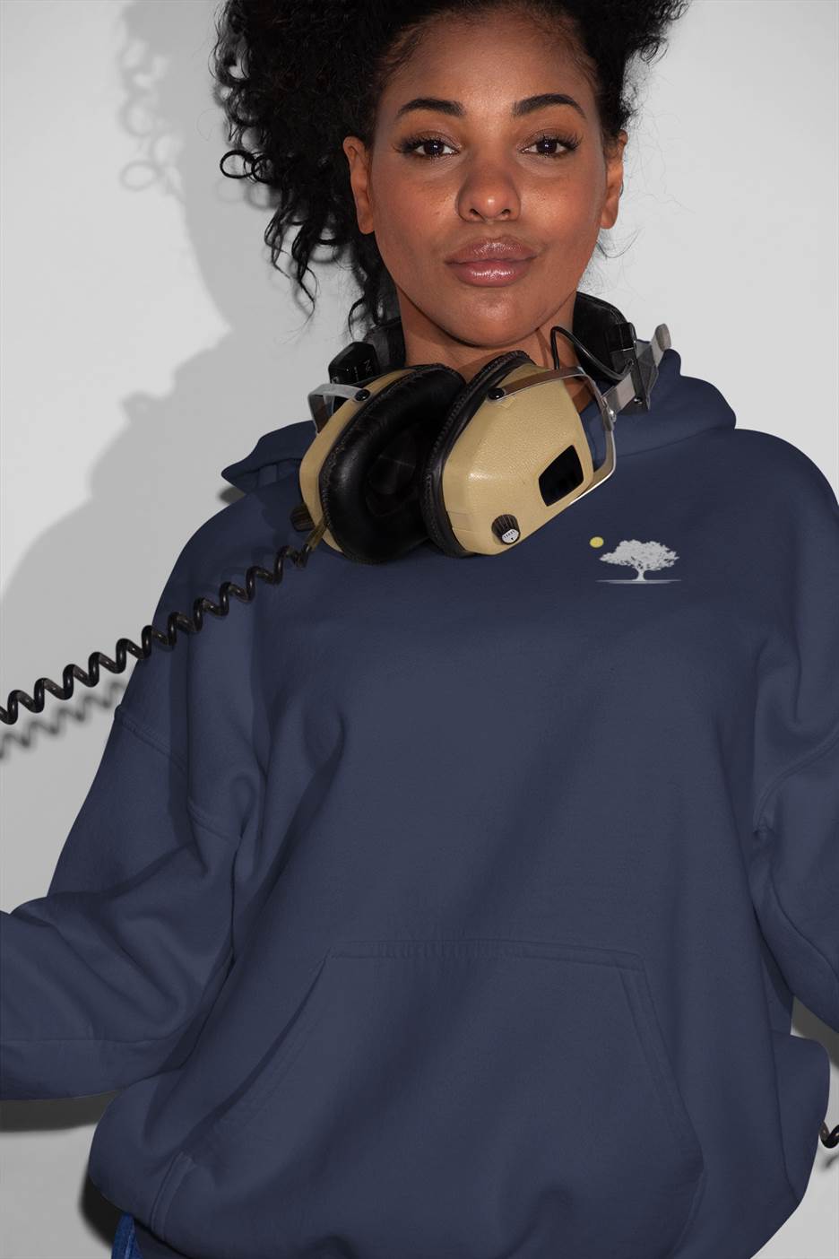 Navy Evora Sunset Minimal Organic Hoodie styled with headphones, blending eco-friendly fashion with modern streetwear aesthetics.