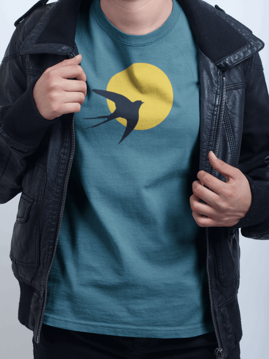 Unisex organic t-shirt featuring the Andorinha logo with a black swallow silhouette against a yellow sun. Made from sustainable cotton, inspired by Portuguese culture.