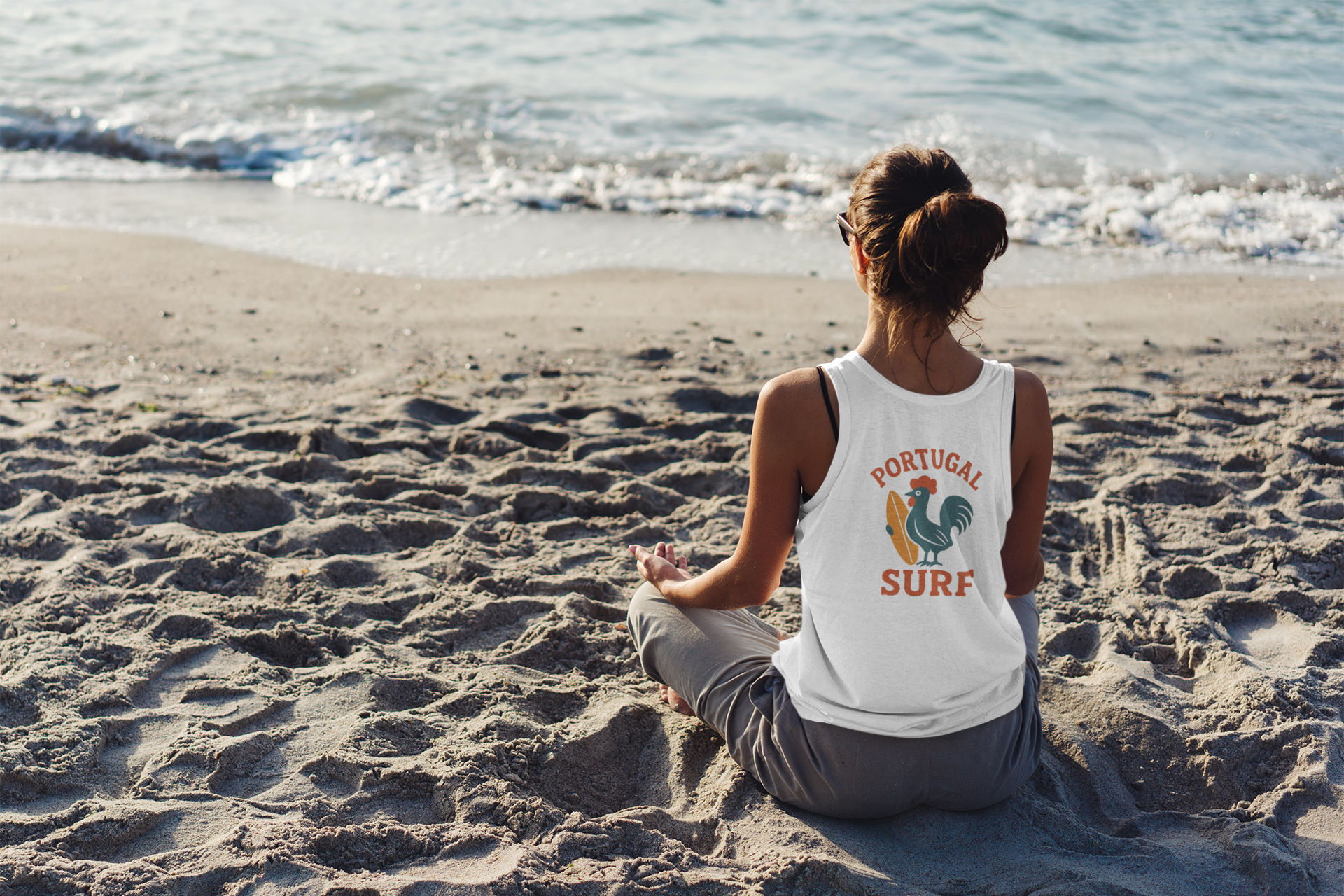 Model wearing the organic surfing Galo tank top at the beach.