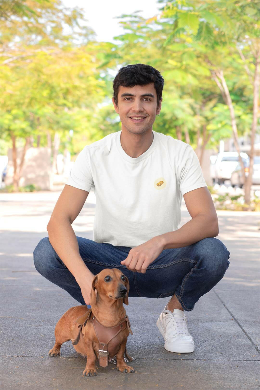 White Pastel de Nata T-Shirt worn by a man squatting with a dachshund. Organic cotton, minimalist Lisbon style.