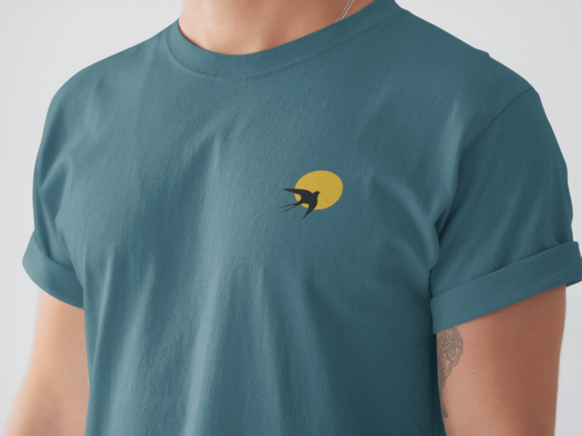Andorinha T-Shirt in deep blue featuring a swallow and sun logo, made from organic cotton. A unisex minimalist tee inspired by Portugal's heritage.