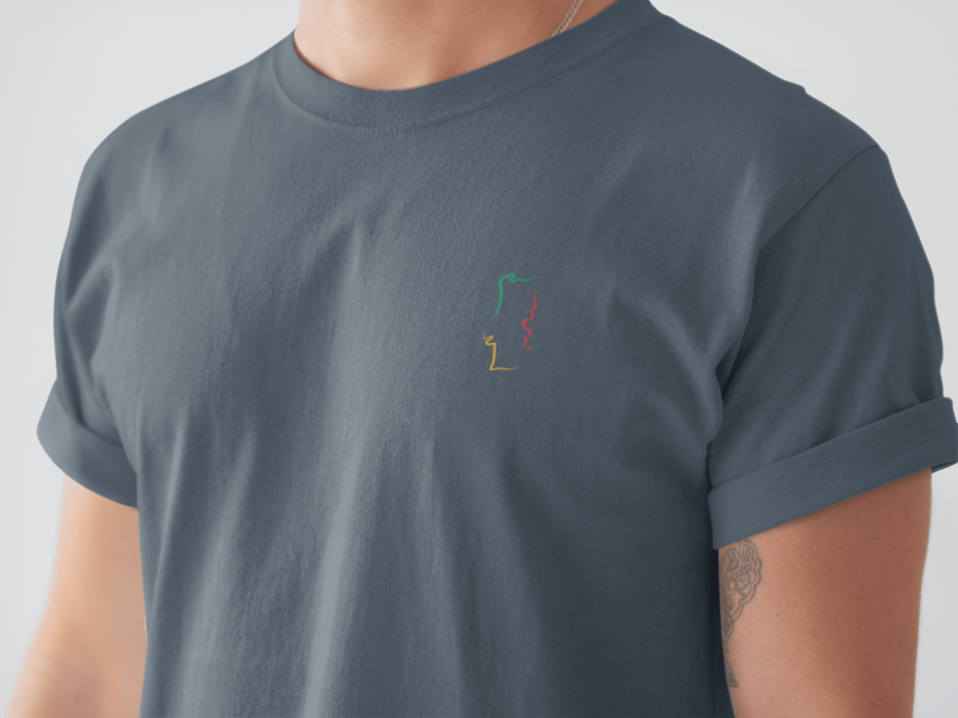 Man wearing a navy blue Portugal T-Shirt with a minimalist embroidered map design, crafted from organic cotton for a stylish and sustainable look.
