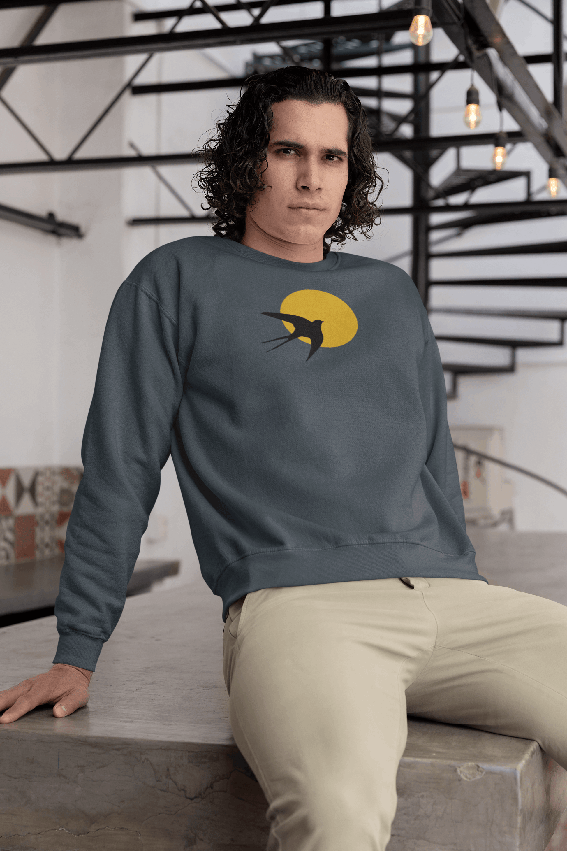 Dark blue unisex organic sweater with a minimal Andorinha swallow logo and yellow sun, made from eco-friendly organic cotton for a timeless style.