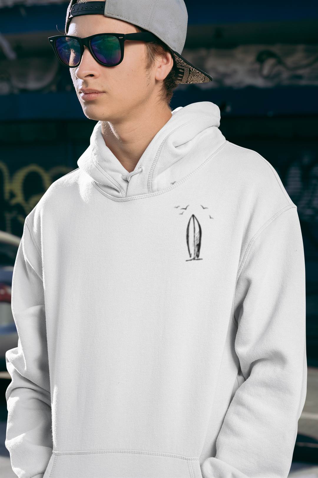 White Ericeira Surf Hoodie worn by a skater with sunglasses. A minimalist and ethical hoodie for urban and surf lifestyles.