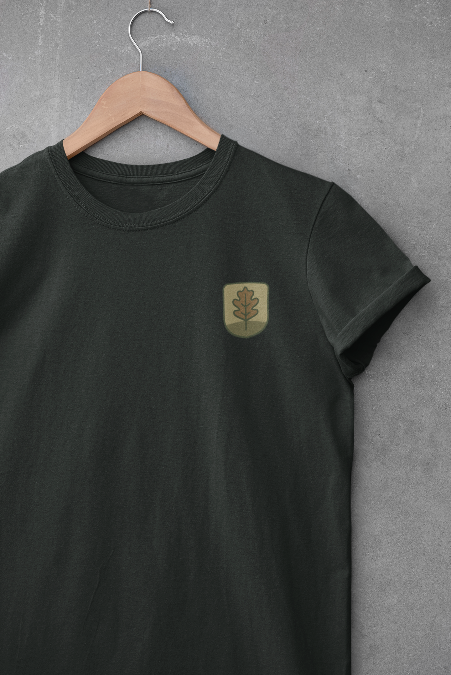Folded eco-friendly t-shirt with oak leaf symbol.