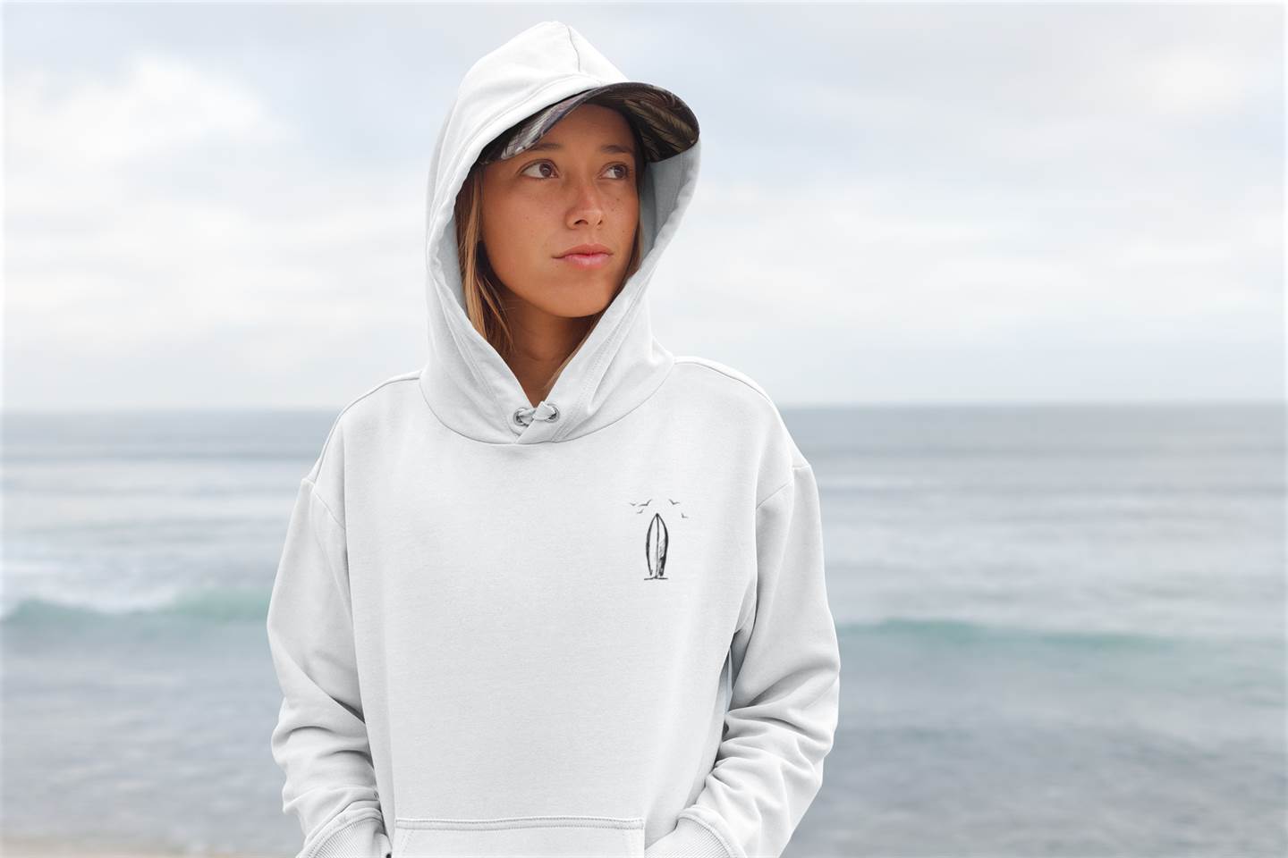 White Ericeira Surf Hoodie with a minimalist surfboard design. A cozy and eco-friendly hoodie for surf lovers and outdoor adventurers.
