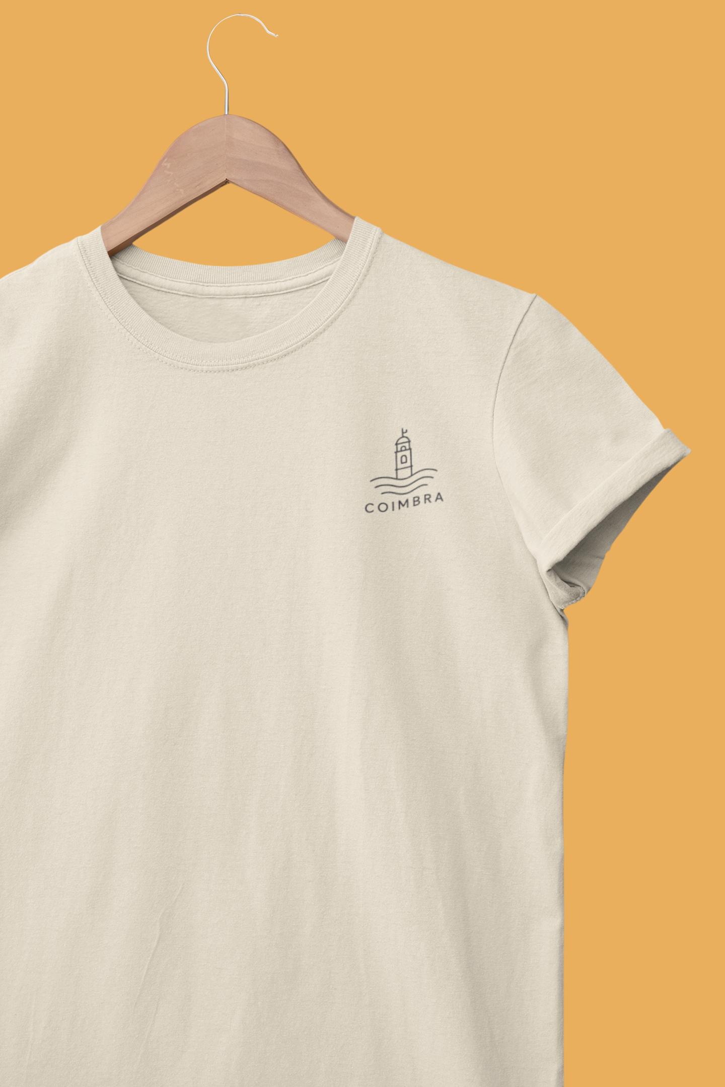 Beige t-shirt with a logo on a hanger against an orange background