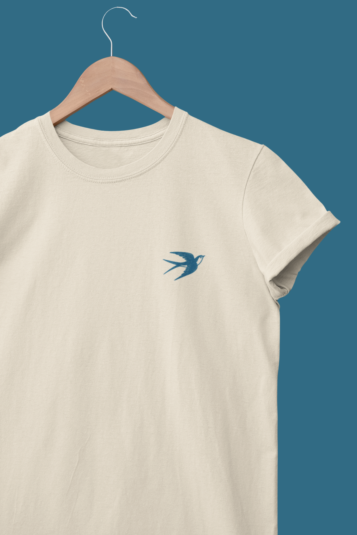 Line-art swallow logo printed on the chest of a white shirt.