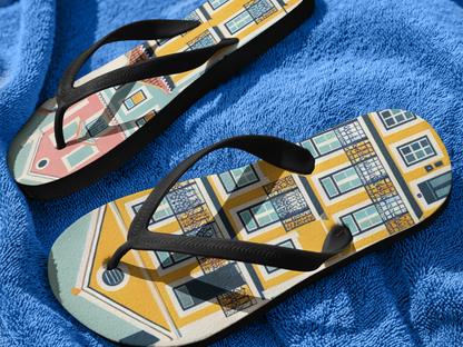 Close-up of Alfama Collection flip flops with Lisbon-inspired design on a blue towel, highlighting their colorful and durable construction.