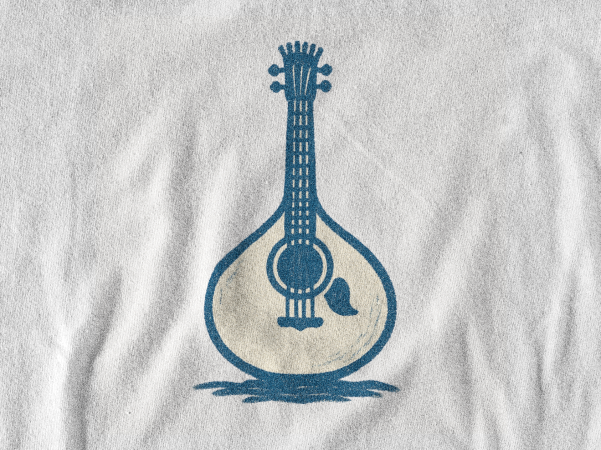 Folded eco-friendly t-shirt with guitar line art.