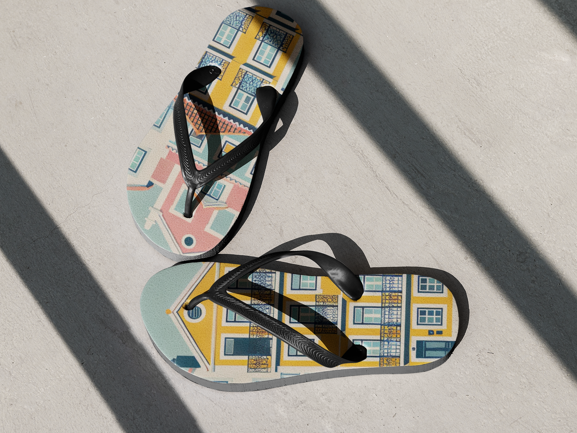 Stylish Alfama Collection flip flops with Lisbon-inspired design placed on a sunlit concrete floor, perfect for summer adventures.