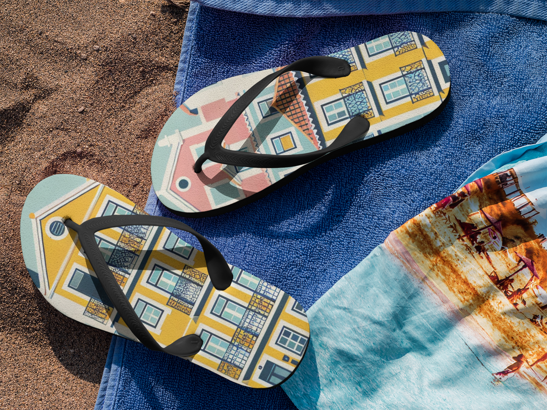 Vibrant Alfama Collection flip flops with Lisbon-inspired design placed on a beach towel, ideal for stylish and durable summer footwear.