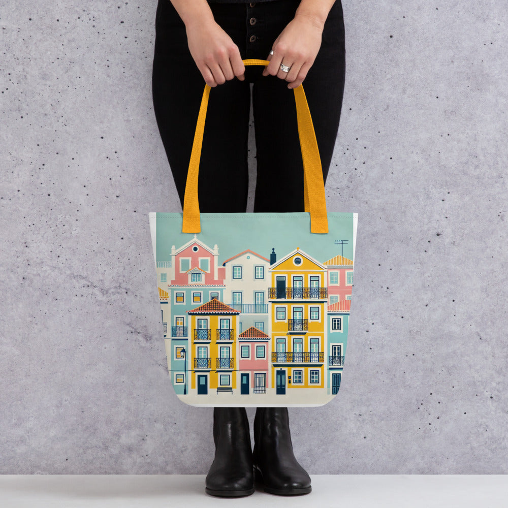 Person holding the Lisbon Tote Bag from the Alfama Collection against a textured wall. Durable and stylish with a spacious interior.