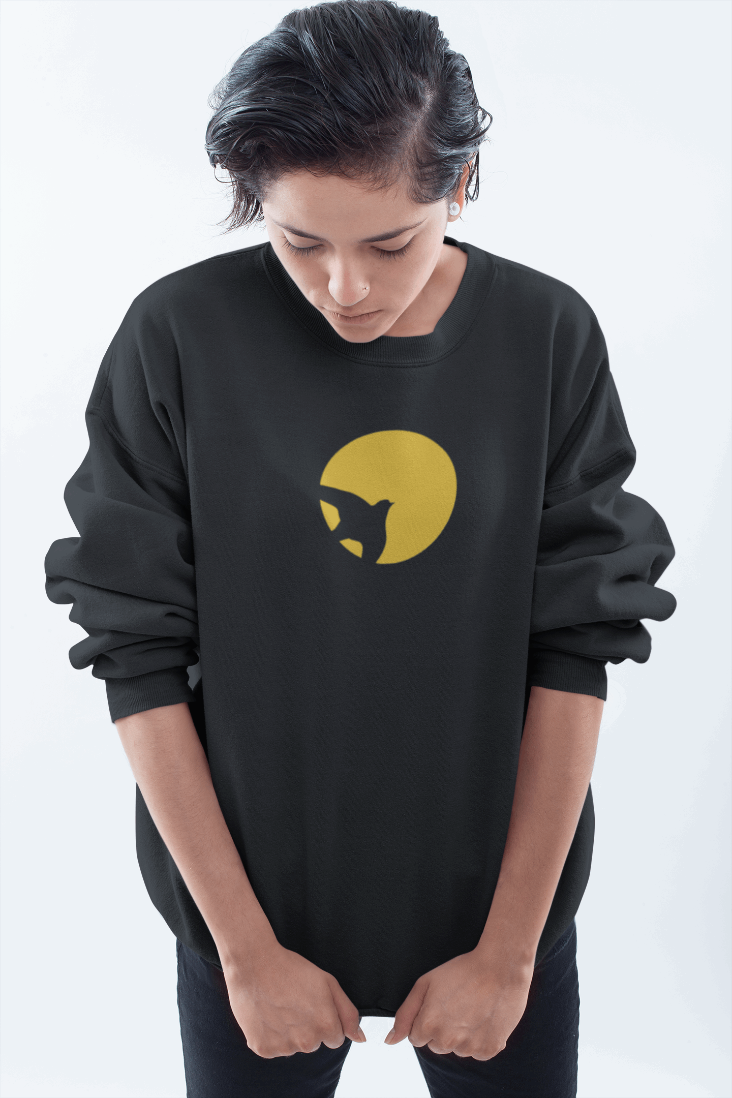 Oversized black unisex organic sweater featuring a minimal cat silhouette logo with a yellow sun, made from organic cotton for a cozy and sustainable fit.