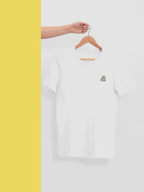 White Minimal Alfama Houses Unisex T-Shirt on a wooden hanger, showcasing its organic cotton material and minimalist Lisbon-inspired design.