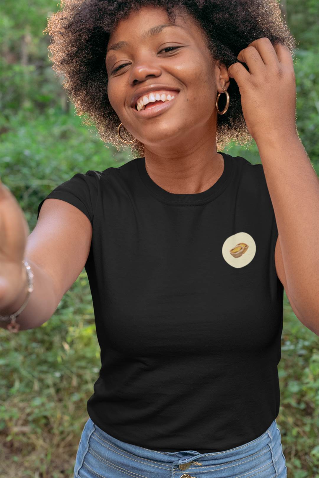 Black Lisbon Style T-Shirt for women featuring a small Pastel de Nata design. Organic cotton tee with a minimalist aesthetic for a casual chic look.