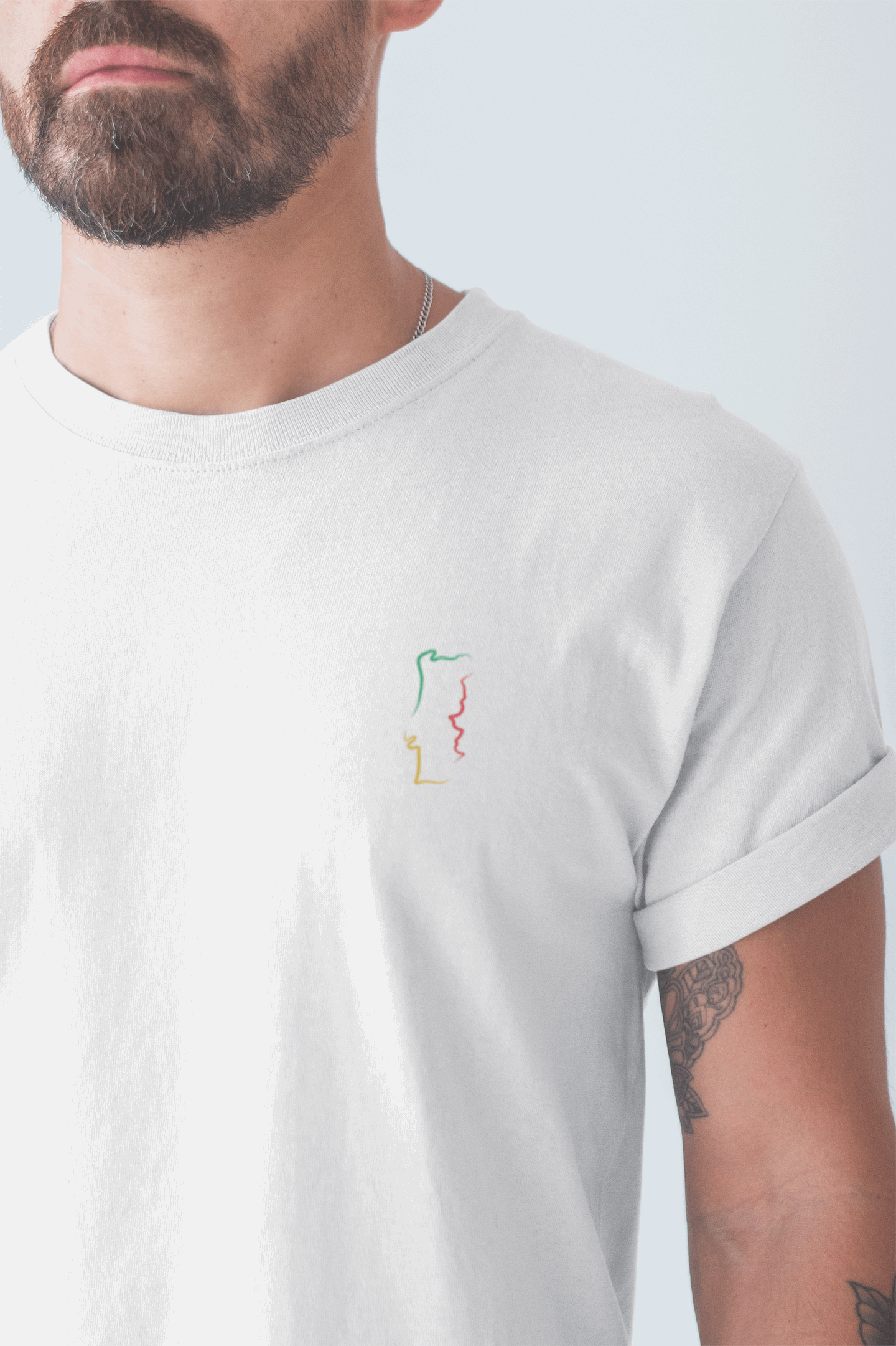 Bearded man in a white Portugal T-Shirt showcasing a minimalist embroidered map design, made from soft organic cotton for a unisex fit.