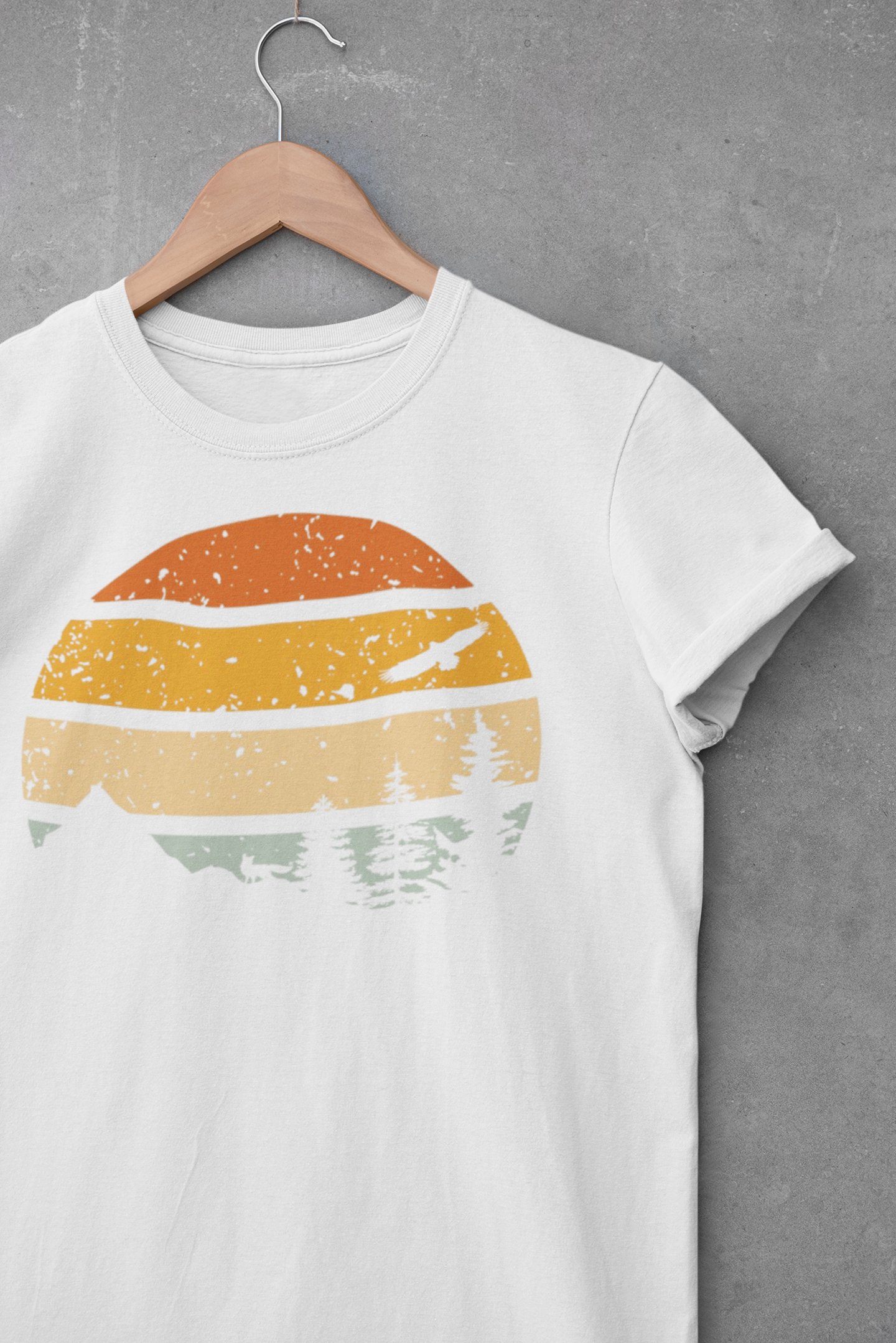 White Madeira Mountains Retro Organic Vintage T-Shirt displayed on a hanger. A soft and eco-friendly hiking tee for nature lovers.