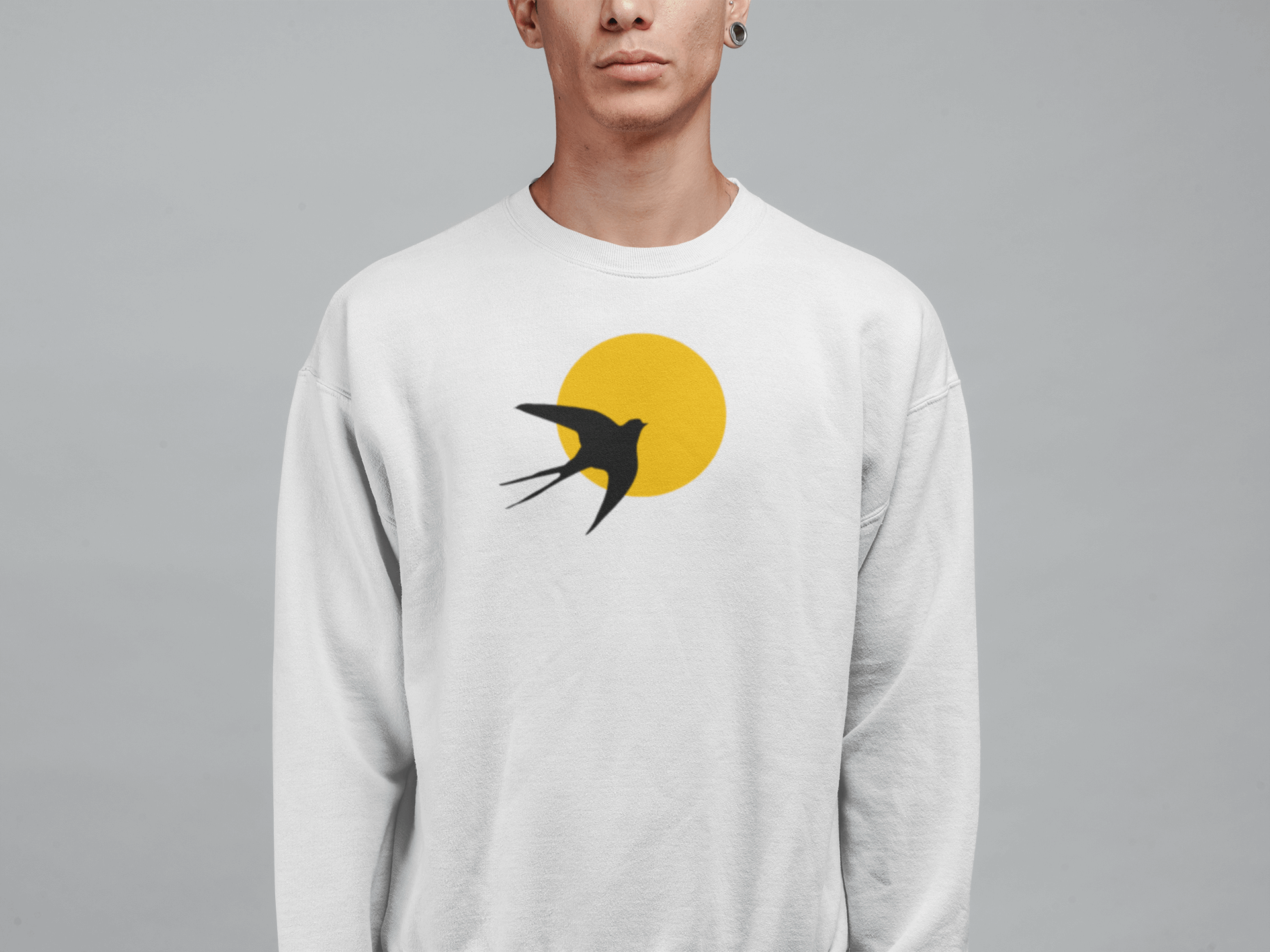 White unisex organic sweater featuring a minimal Andorinha swallow logo with a yellow sun, made from soft organic cotton for a sustainable wardrobe choice.