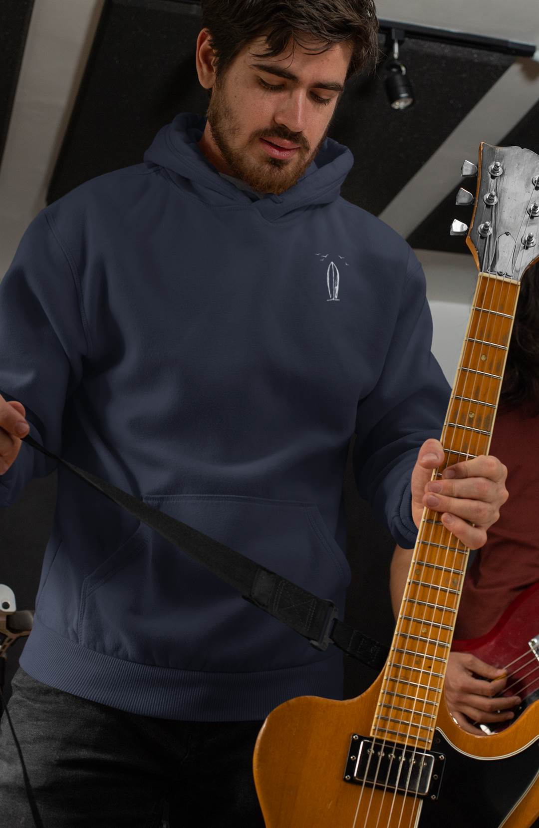 Dark blue Ericeira Surf Hoodie worn by a musician. Organic and unisex, blending surf culture with everyday casual wear.