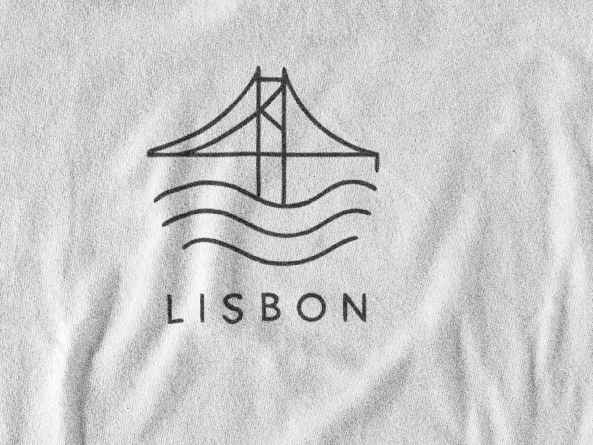 Sustainable tee with Portugal capital graphic.