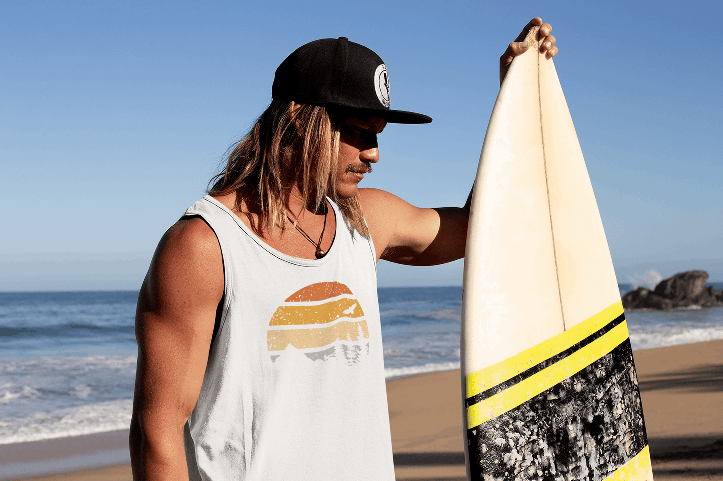 Men's white Madeira Vintage Tank Top with a retro sunset design. Organic cotton fabric, perfect for surf culture and outdoor adventures.
