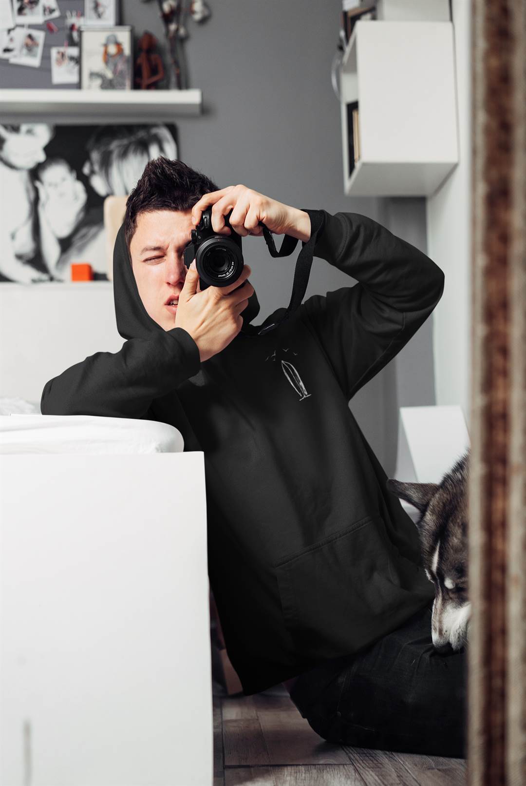 Black Ericeira Surf Hoodie worn by a photographer indoors. A sustainable and stylish choice for creatives and surf enthusiasts alike.