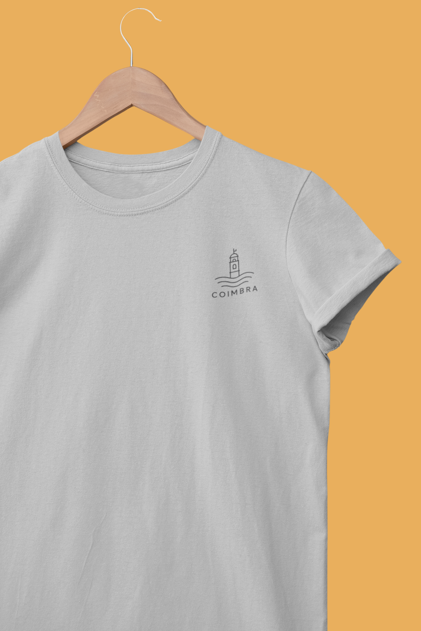 Gray t-shirt with a logo on a hanger against an orange background