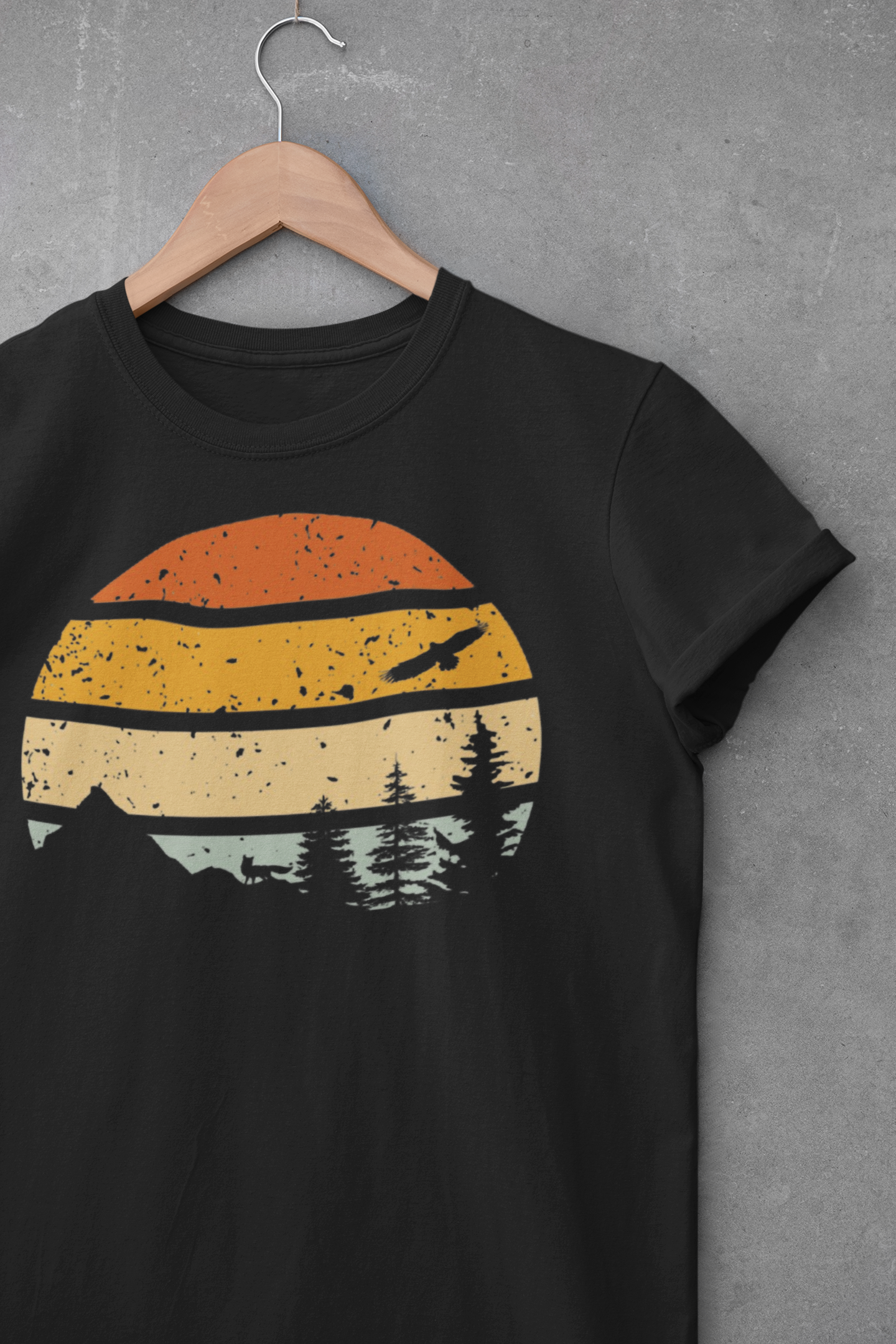 Black Madeira Mountains Retro Organic Vintage T-Shirt displayed on a hanger. A vintage-style hiking tee for outdoor lovers.