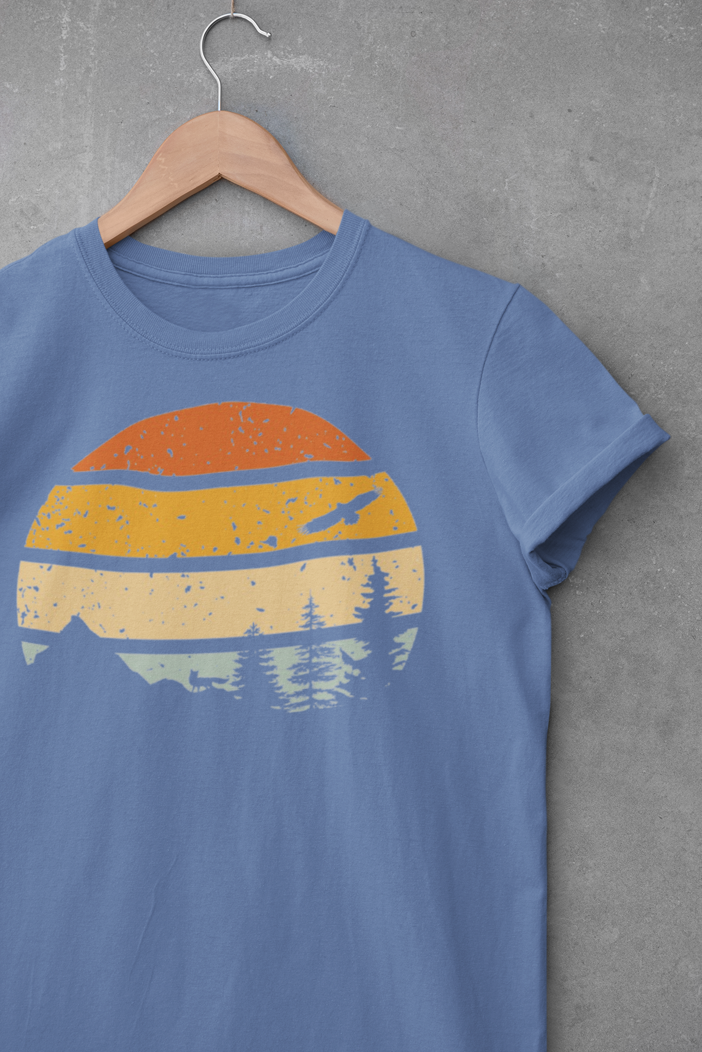Blue Madeira Mountains Retro Organic Vintage T-Shirt displayed on a hanger. A soft and eco-friendly hiking tee for nature lovers.
