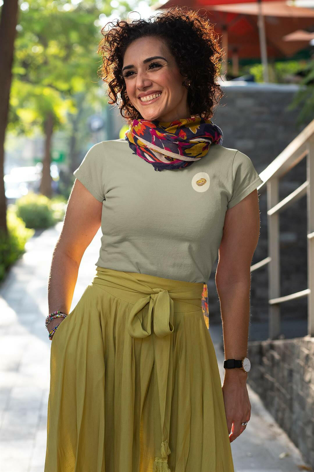 Beige Lisbon Style T-Shirt for women with a minimalist Pastel de Nata print. Organic cotton tee styled with a colorful scarf and a flowing skirt.