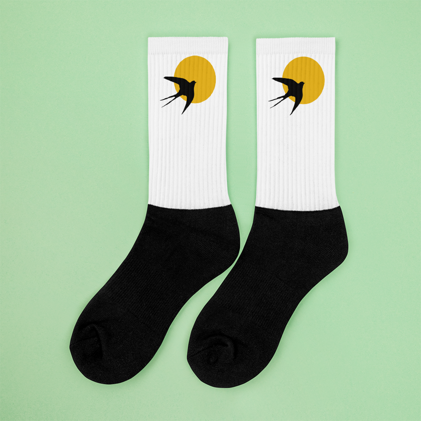 Detailed view of sunset and swallow artwork on socks