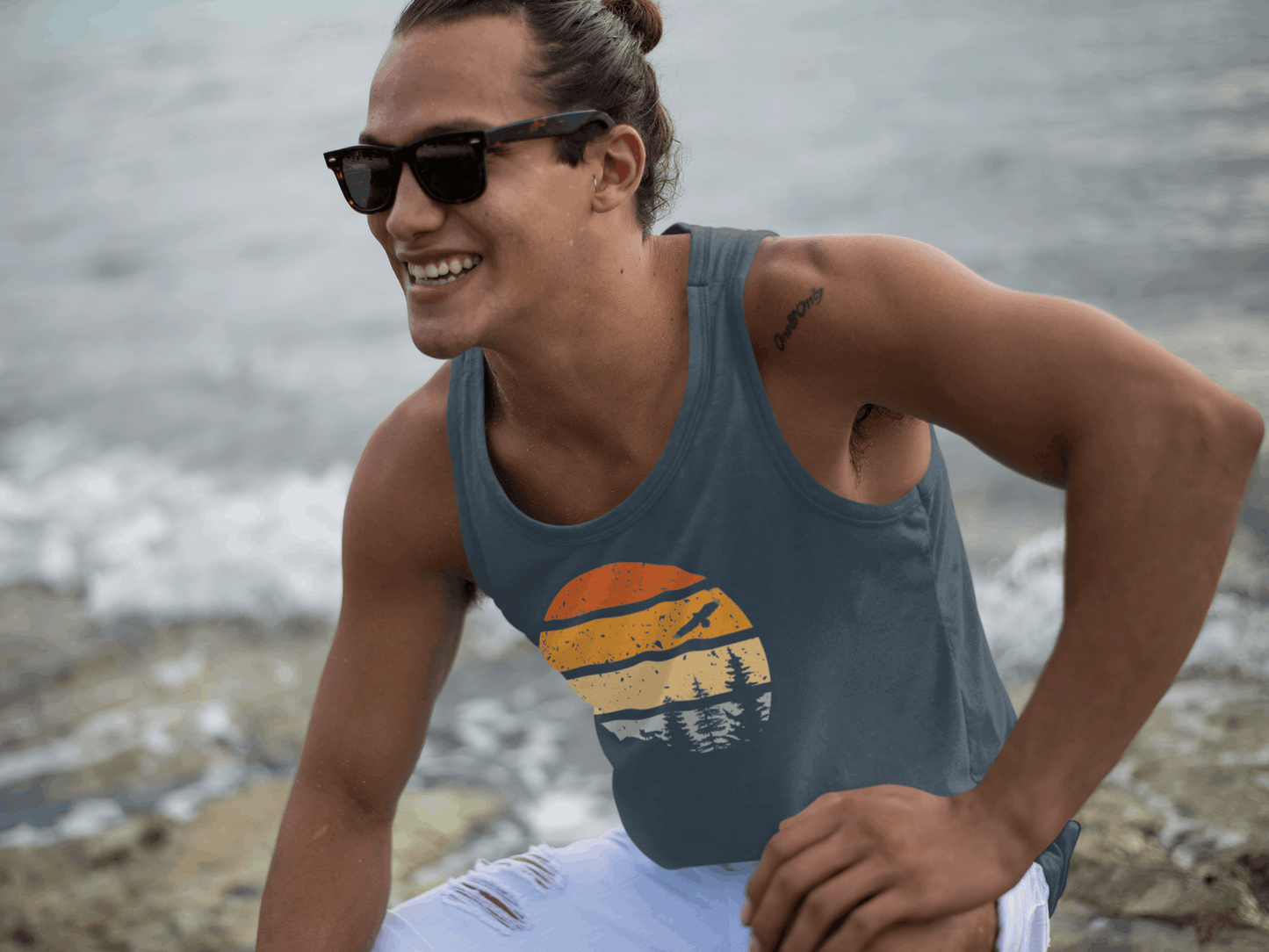 Men's Madeira Vintage Tank Top in blue, crafted from organic cotton. Features a retro hiking-inspired sunset design, ideal for outdoor activities.