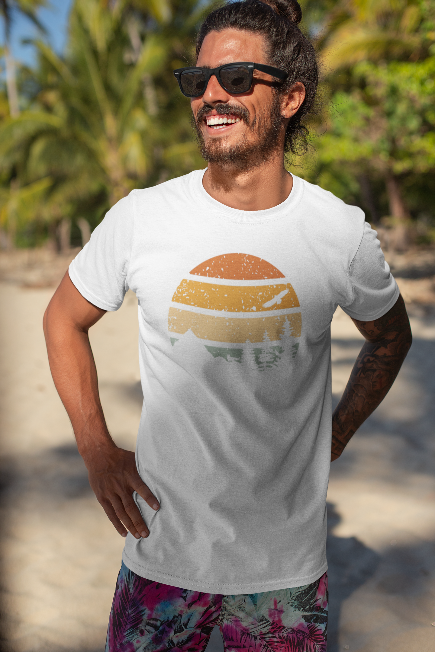 Man on the beach wearing a white Madeira Mountains Retro Organic Vintage T-Shirt with sunglasses. A perfect summer hiking tee.