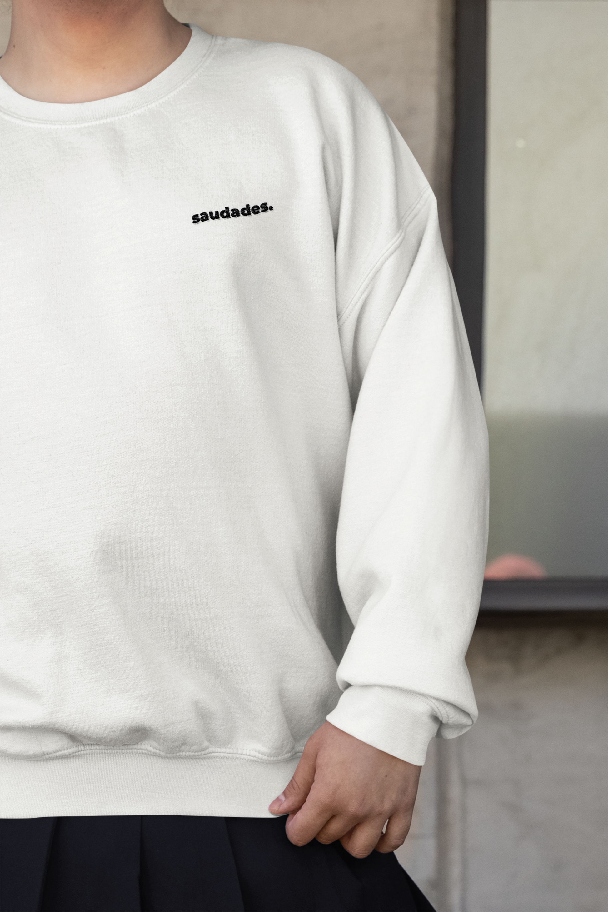 Model wearing Saudade sweatshirt styled with casual surf lifestyle outfit