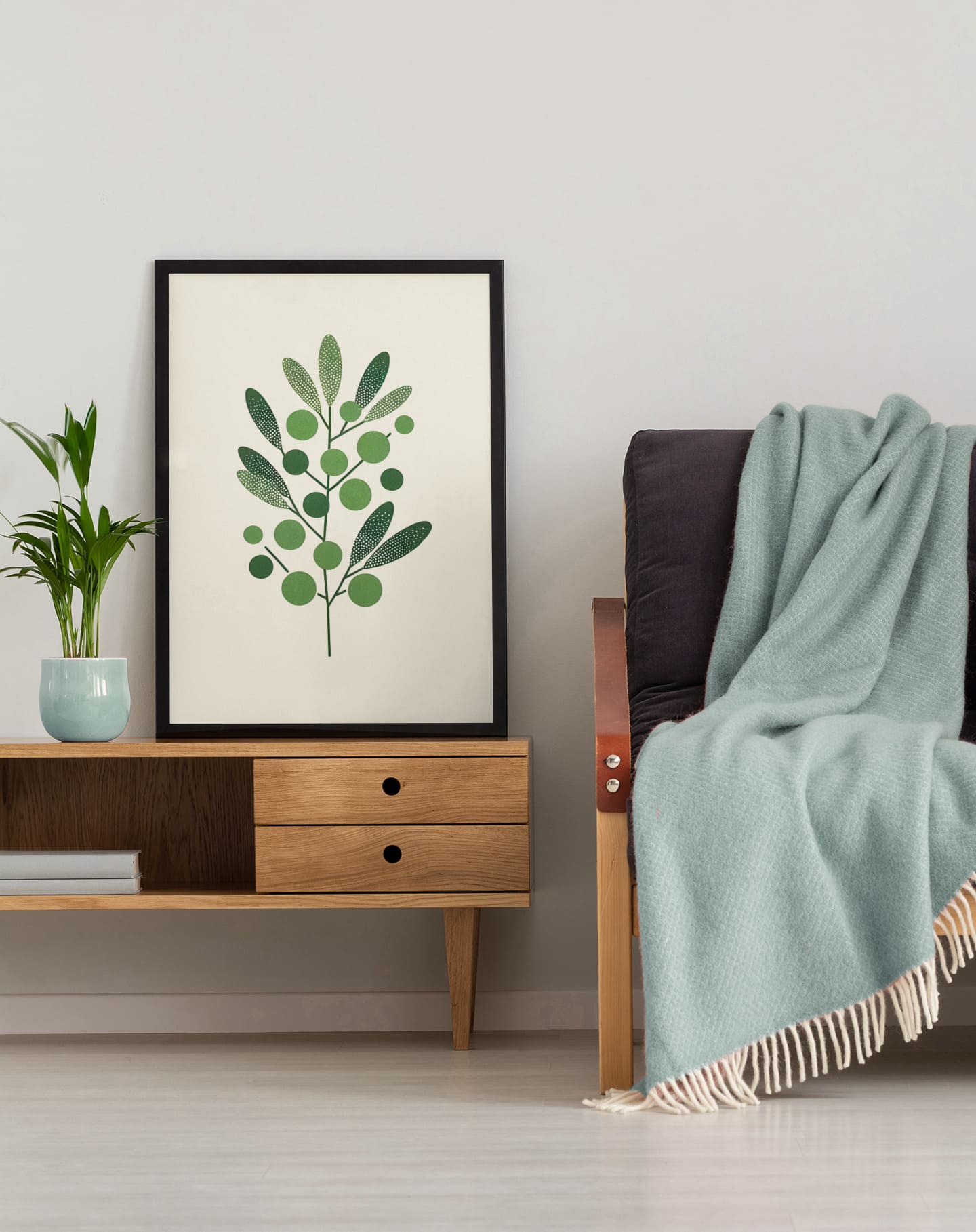 Olive Branch Minimalist Poster in a black frame, styled in a cozy living space with wooden furniture and soft textiles. A perfect nature-inspired accent.