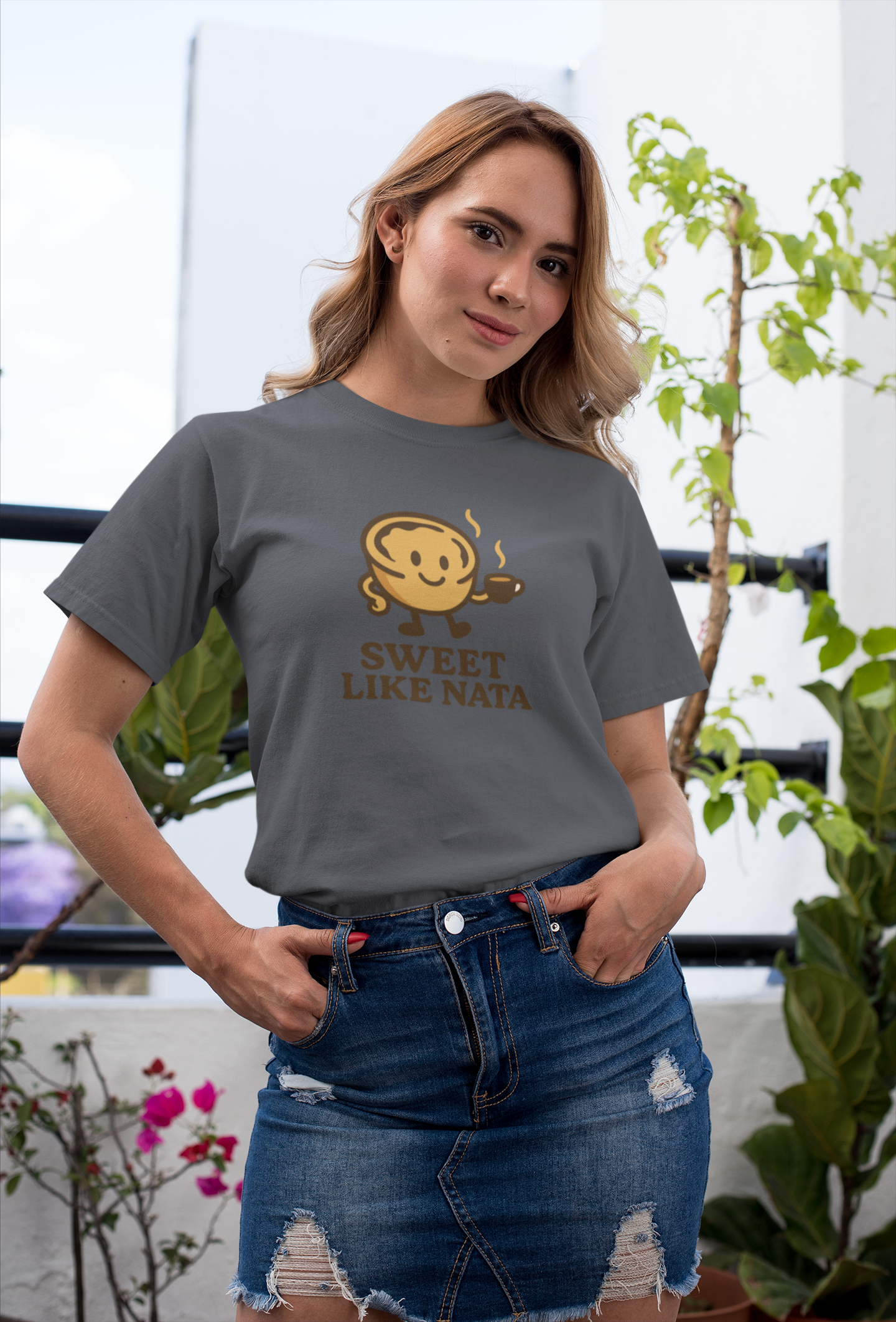 Happy woman in white tee with Portuguese pastry graphic.