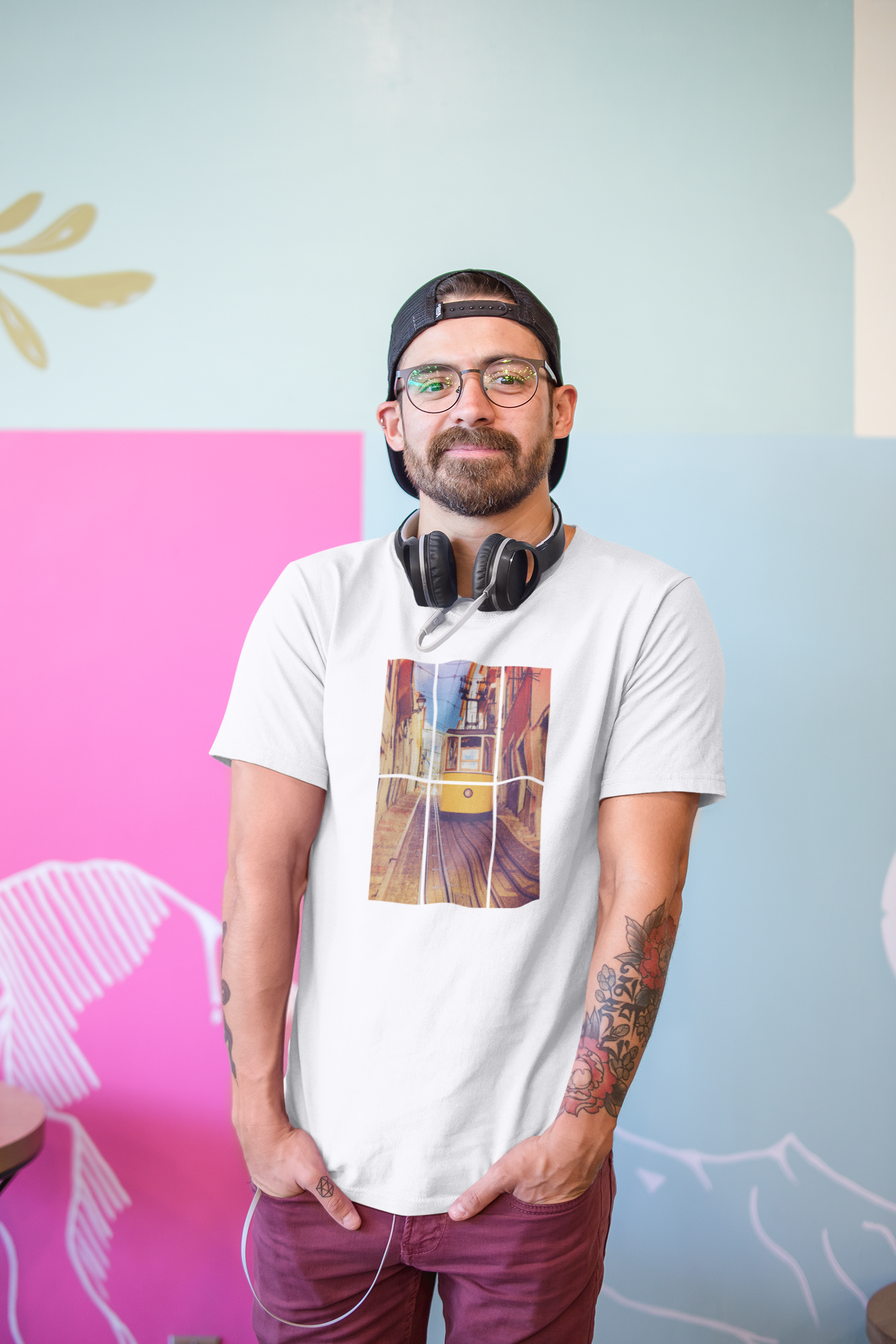 Man in a Lisbon Tram T-shirt with headphones around his neck, posing casually. Crafted from organic and eco-friendly fabric for a premium and sustainable fit.