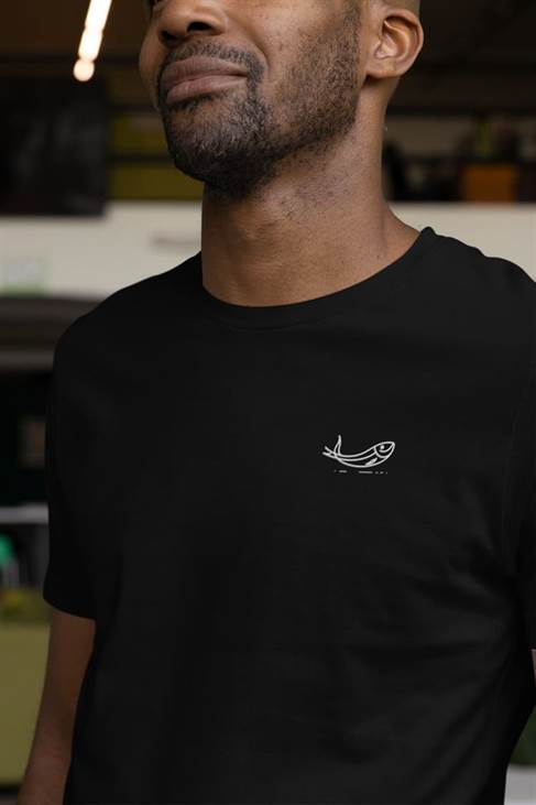 Black unisex sardine t-shirt with minimalist embroidered fish design. A stylish and eco-friendly choice made from organic cotton.
