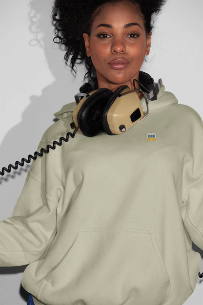 Light green organic Ericeira Surf Hoodie with a small embroidered design. A unisex ethical fashion choice for comfort and sustainability.