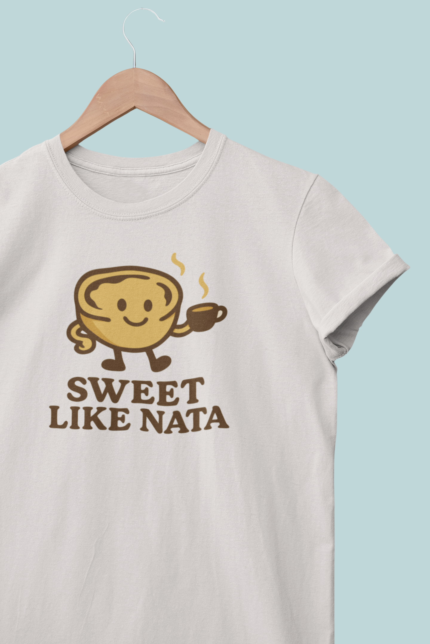 Woman wearing a white “Sweet Like Nata” t-shirt with a pastel de nata graphic.