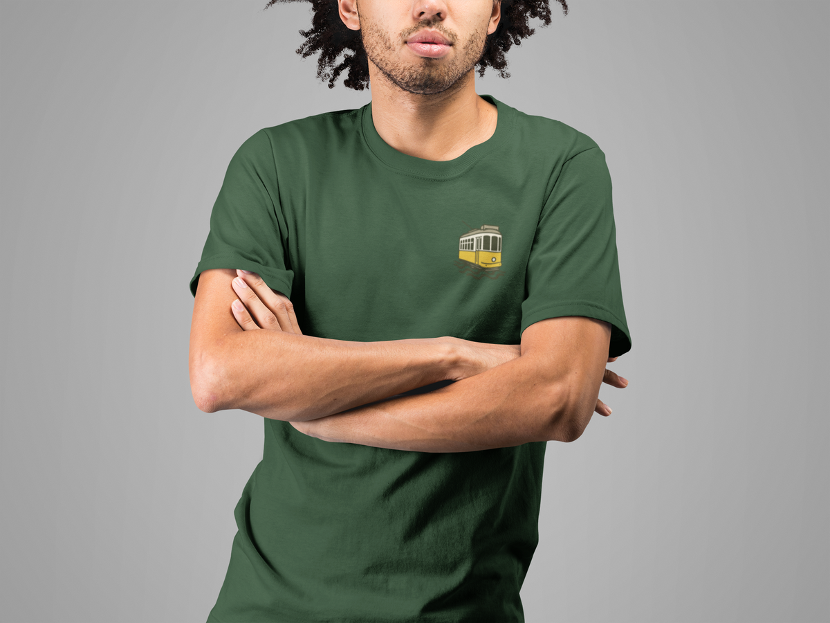 Person wearing a green t-shirt with a small logo on a gray background