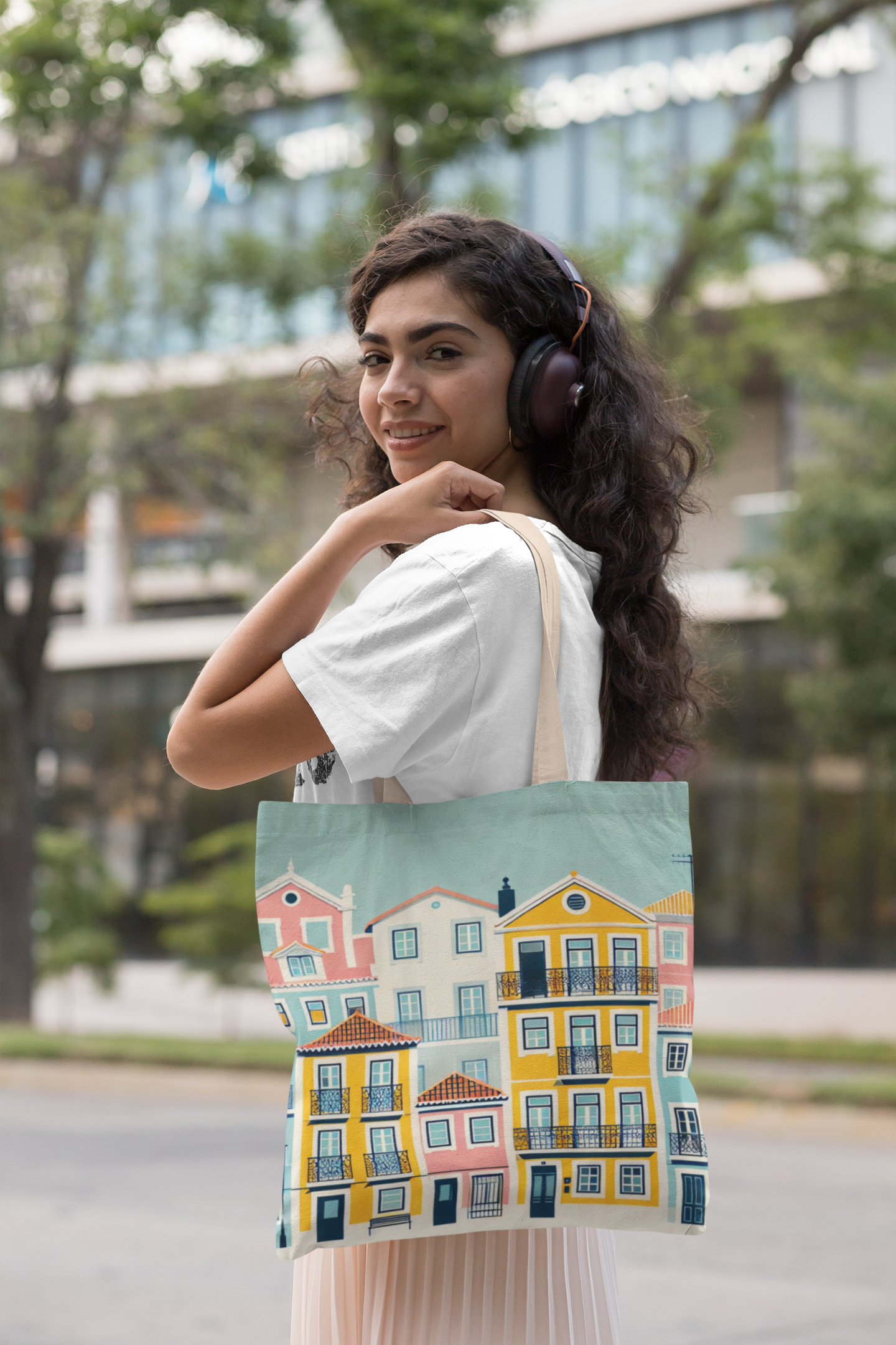 Smiling woman wearing headphones carrying the Lisbon Tote Bag from the Alfama Collection. A fashionable and eco-friendly tote for any occasion.