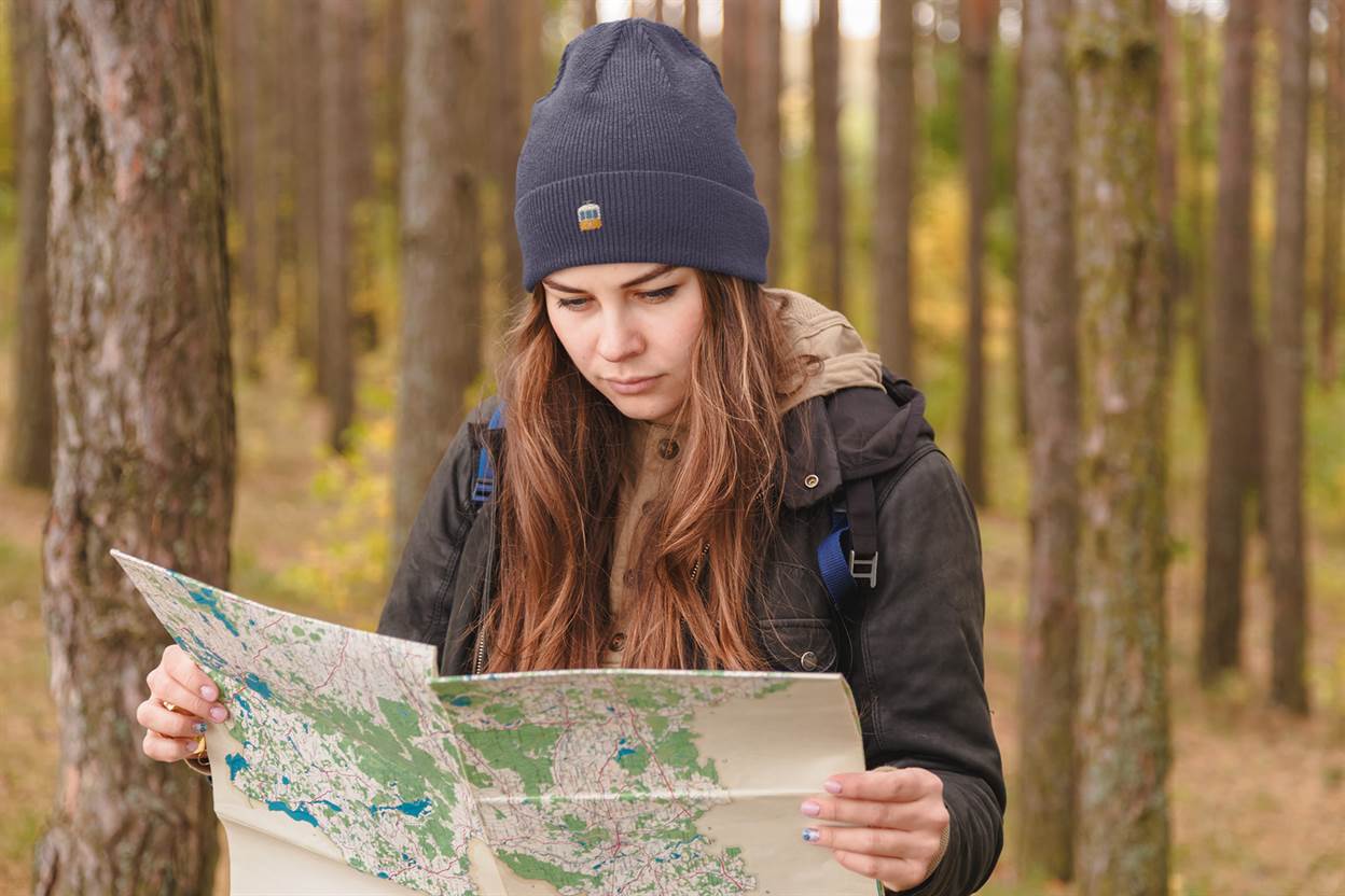 Navy blue Lisbon Electrico Beanie worn during an outdoor adventure. A cozy and stylish embroidered hat inspired by Lisbon's heritage.