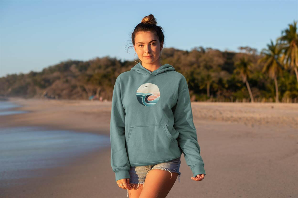 Teal Nazaré Surf Wave Hoodie with a vintage surf-inspired design. Unisex organic cotton hoodie for a relaxed and stylish beach look.