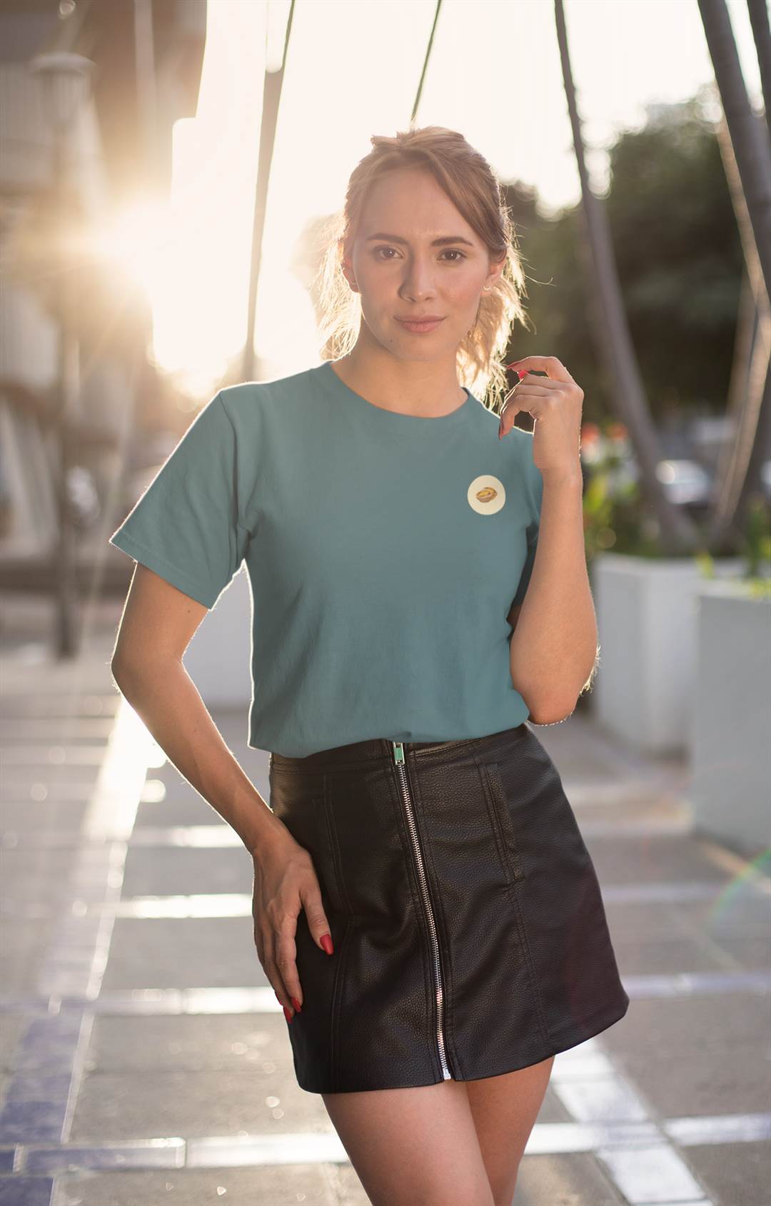 Teal Lisbon Style T-Shirt for women featuring a minimalist Pastel de Nata design. Organic cotton tee paired with a black skirt for a trendy outfit.